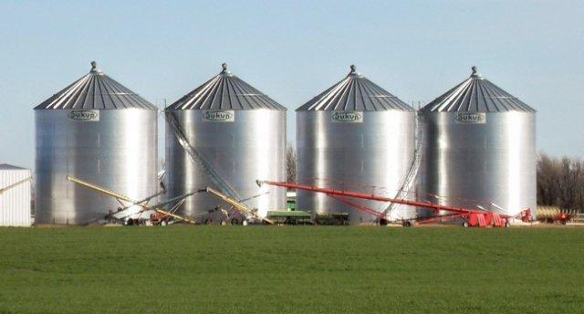 Four large Sukup grain storage bins