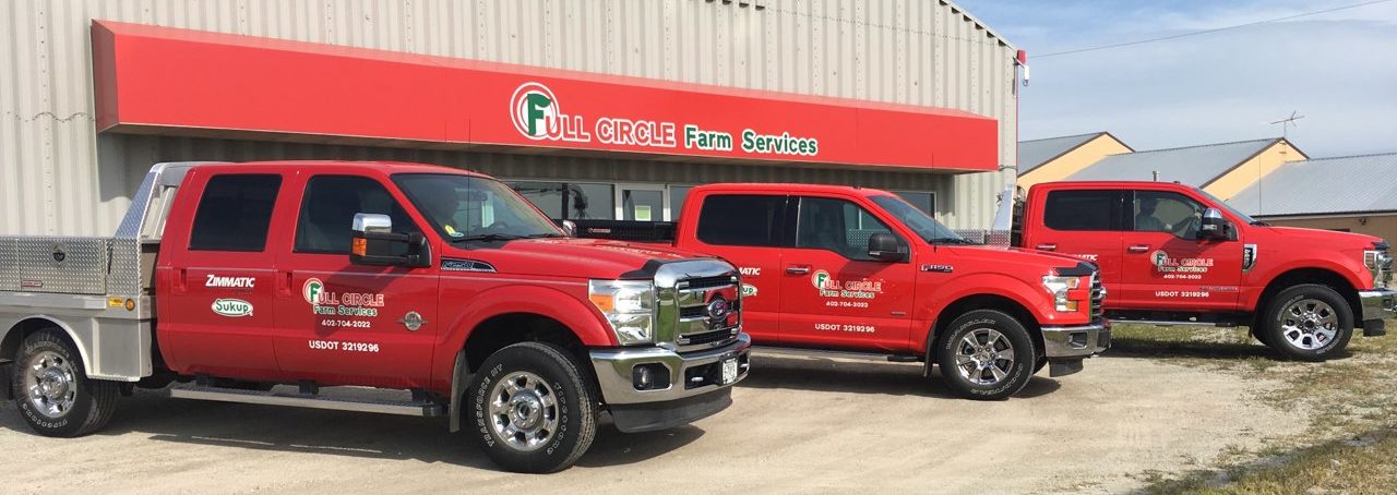 Full Circle Farm Services trucks parked in front of their shop